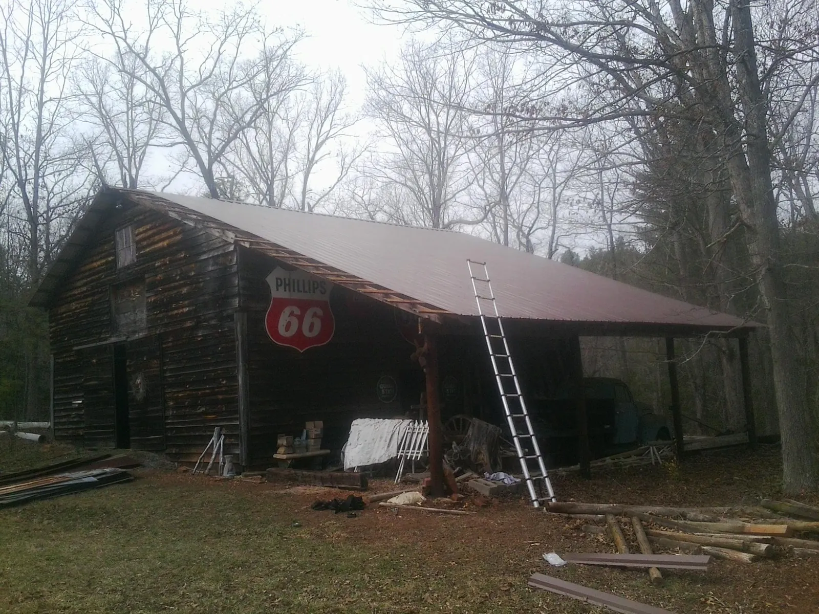 New metal roof on an open sided timber barn with a vintage sign in Grayland